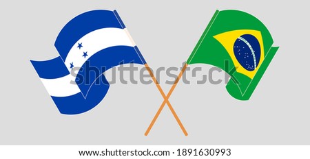 Crossed and waving flags of Honduras and Brazil