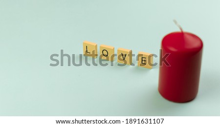 Love theme minimal concept background with word and red candle, banner for Valentine's Day photo, copy space