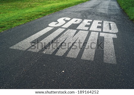 Speed Limit message reminder on rainy asphalt road. Concept of safe driving and preventing traffic accident.