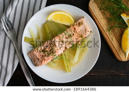 Poached Salmon with Fennel and Lemon: A piece of herbed salmon over boiled fennel cooked in lemon broth