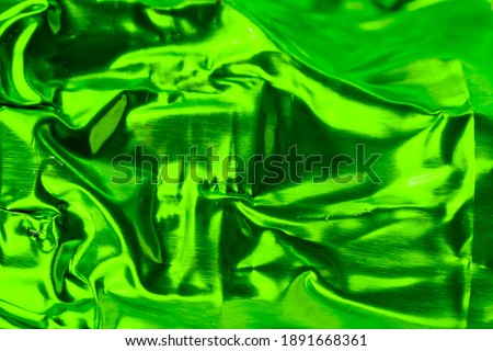 crumpled aluminum foil painted green. background or texture
