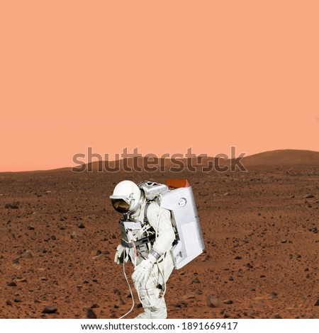 Astronaut walking on planet Mars. Mars travelling. The elements of this image furnished by NASA.

