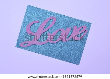 Wooden letters Love on glitter paper. Happy Valentines Day.