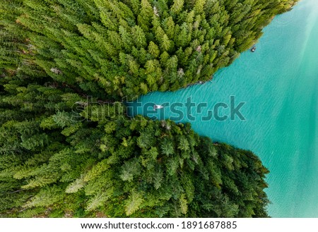 Boat moored in a cove with green forests all around aerial view Royalty-Free Stock Photo #1891687885