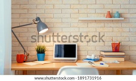 Office workplace with laptop on wooden table.                                Royalty-Free Stock Photo #1891731916