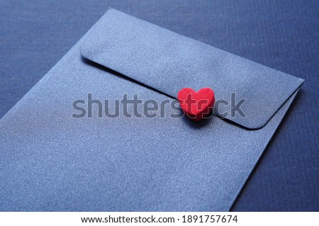 Red hearts on elegant blue paper envelopes background. Concept of love and encouragement.
