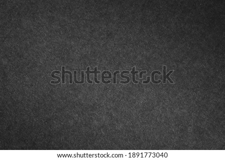 Black paper texture in background.