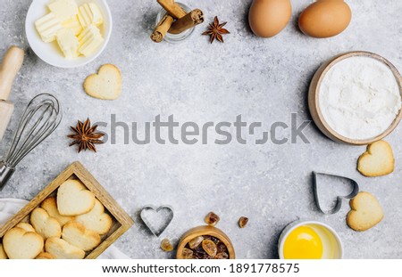Valentine's Day baking culinary background. Ingredients for cooking on wooden kitchen table, baking recipe for pastry. Heart shape cookies. Top view. Flat lay. Royalty-Free Stock Photo #1891778575