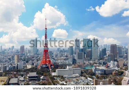 
Beautiful city skyline of Downtown Tokyo, with the famous landmark Tokyo Tower standing out amid the crowded skyscrapers under blue sunny sky and Zoujouji temple located in the nearby Shiba Koen Park
