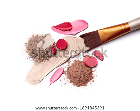 Smears of foundation for face. Pink red lipstick smeared on white background. Loose Eye Shadow. Cosmetic products. Beauty and makeup concept