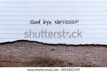 Lined sheet paper on old vintage wood background with handwritten text GOOD BYE NARCISSIST , concept of ldealing with toxic people who craving admiration and lacking empathy Royalty-Free Stock Photo #1891862149