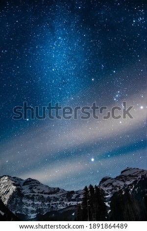 Picture of the night sky, snowy mountains in the background