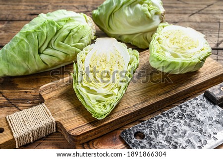 Fresh Green pointed cabbage. Wooden background. Top view.