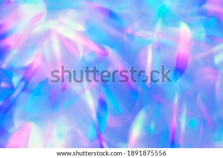 beautiful defocused vibrant blue and purple bokeh lights background of holographic foil for your festive project