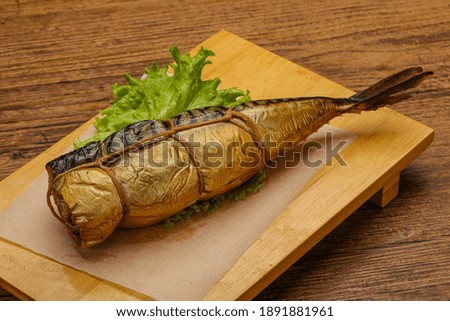 Smoked tasty mackerel fish snack over board
