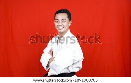 Asian karate man smile with black belt