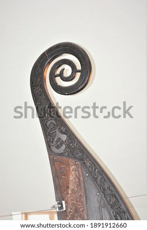 A photo of the beautifully decorated Oseberg prow at Viking Ship Museum in Oslo, Norway.