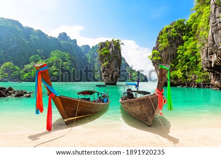 Famous James Bond island near Phuket in Thailand. Travel photo of James Bond island with thai traditional wooden longtail boat and beautiful sand beach in Phang Nga bay, Thailand. Royalty-Free Stock Photo #1891920235