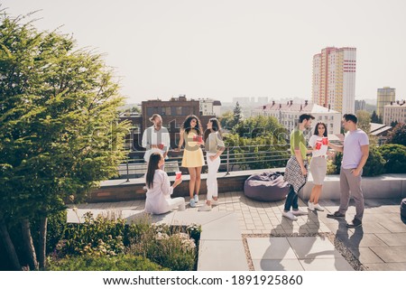 Full body photo of young friends gathered together have fun enjoy chill rooftop party drink chat communicate Royalty-Free Stock Photo #1891925860