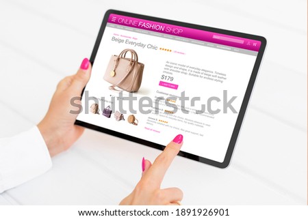 Woman looking for new bag in online store on digital tablet