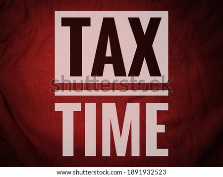 TAX TIME word on red abstract background