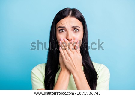 Photo portrait of scared woman covering mouth with two hands isolated on pastel blue colored background Royalty-Free Stock Photo #1891936945
