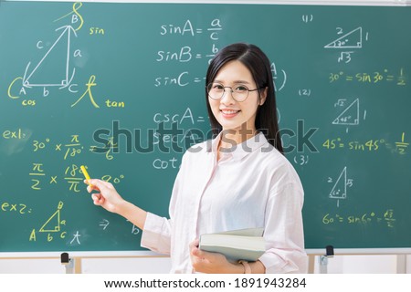 asian senior high school female teacher is teaching online through webcam in classroom Royalty-Free Stock Photo #1891943284
