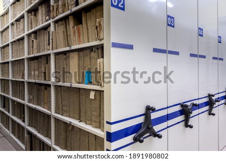 mobile shelves with documents. Archive or office, archive, file, registration Royalty-Free Stock Photo #1891980802