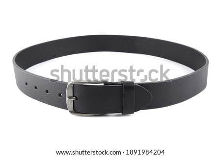 Fastened fashionable men's leather belt with dark matted metal buckle isolated on white background. Black belt for men. Black leather belt for trousers and jeans. Male accessory. Royalty-Free Stock Photo #1891984204