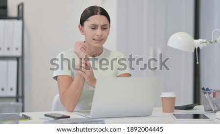 Young Latin Woman with Laptop having Wrist Pain 