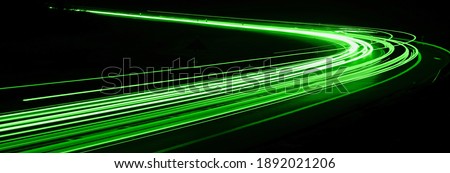 green car lights at night. long exposure Royalty-Free Stock Photo #1892021206