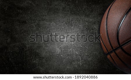 Basketball ball on dark concrete wall texture background. Background for product display, banner, or mockup