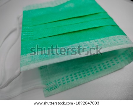 a three layer green mask with effective protection suggested by health experts