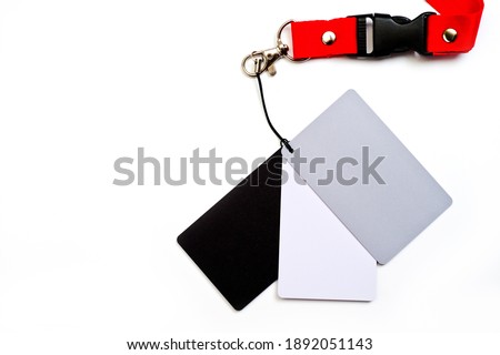 A set of 3 cards white, gray and black for determining the exact white balance, a gray card for photographing.