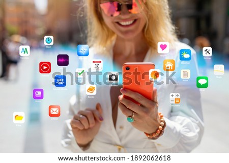 Concept of person using different everyday apps on mobile phone. All icons are made up.