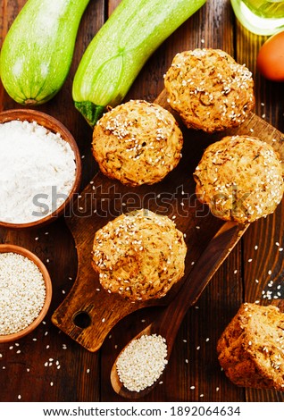 Zucchini muffins with sesame seeds on the table