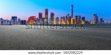 Asphalt road and modern city commercial buildings in Beijing at night,China.