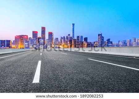 Asphalt road and modern city commercial buildings in Beijing at night,China.