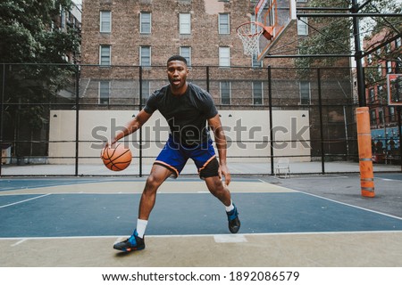Cinematic image of a basketball player training on a court in New york city Royalty-Free Stock Photo #1892086579