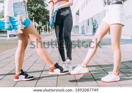 Cinematic image of three friends going out together. Concepts about lifestyle and social distance in 2020