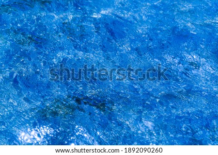 Texture. background. template. pool water - light breeze, play of sunlight and waves from the water