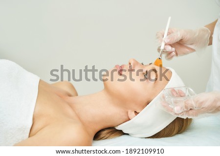 Portrait of moisturizing mask for medical design. Woman skin procedure. Natural cosmetic products. Beauty face. Facial cosmetology treatment. Healthcare peeling cream. Apply to female neck Royalty-Free Stock Photo #1892109910