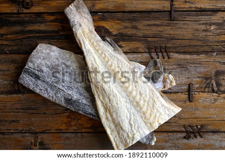 dried chopped cod lies on a wooden table, top view.