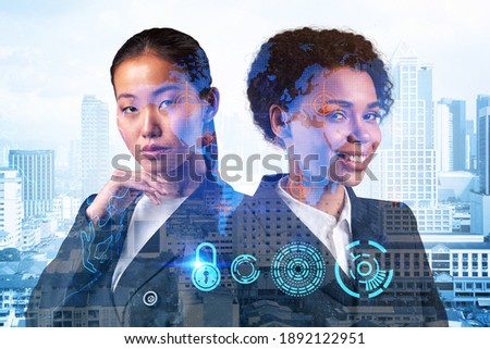 Two young attractive businesswoman in suits thinking about career opportunities at cybersecurity compliance to protect clients confidential information. IT lock icons over Kuala Lumpur