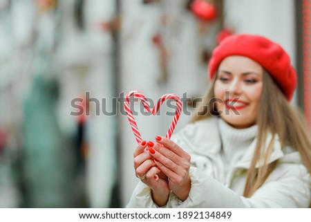 Christmas shopping. Young woman holding a Christmas lollipop. Holidays.