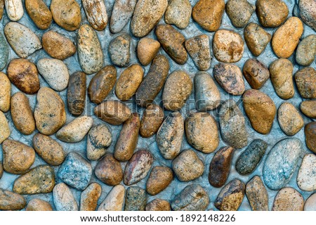 The wall is decorated with rough sea pebbles in the form of grunge.