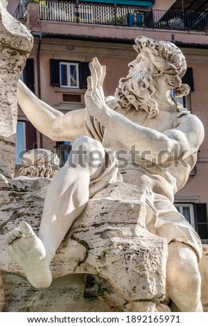 Statue of River Danube part of the Four Rivers Fountain from 1651 by Gian Lorenzo Bernini in baroque style located in the center of Navona Square in Rome, Lazio reigon, Italy Royalty-Free Stock Photo #1892165971