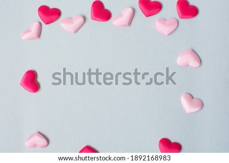 Pink hearts pattern on blue paper
