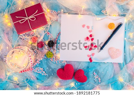 wooden letter block, feather, little gift box, heart shape and light decorative in box present. Love, Valentine and holiday concept.
