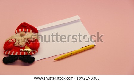 a letter for Santa Claus in an envelope, Santa Claus and a pen on a light background